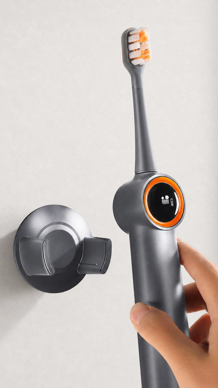 A hand holding an AirJet X3 and putting it onto its wall mount wireless magnetic charger.